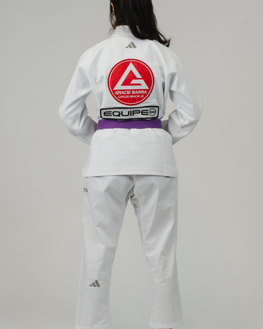 Woman wearing the white adidas Pro Lite Comp Kimono with Gracie Barra branding, shown from the back against a white background.
