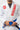 Chest detail of the white 40 Year Anniversary Kimono with the red and gold Gracie Barra lapel patch, Barra Shield, and reinforced collar.