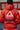 Back view of the 40 Years Competition Team red zip hoodie worn in a Gracie Barra jiu-jitsu school, featuring the large Barra Shield logo and Jiu-Jitsu back graphic in a unisex fit