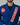Close-up of front collar on men’s blue Pro Lite Comp Kimono by adidas with red Gracie Barra patch on light gray background