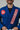 Close-up of front collar on men’s blue Pro Lite Comp Kimono by adidas with red Gracie Barra patch on light gray background