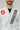 Close-up of upper torso wearing Pro Lite Comp Men’s Kimono by adidas in white featuring embroidered Gracie Barra patches on shoulder and lapel