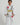Child wearing a white Pro Lite Comp Youth Kimono by adidas with Gracie Barra branding on a white background