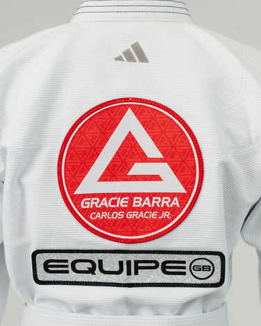 Close-up of back of Pro Lite Comp Men’s Kimono by adidas in white featuring embroidered Gracie Barra, EQUIPE, and adidas logos above belt