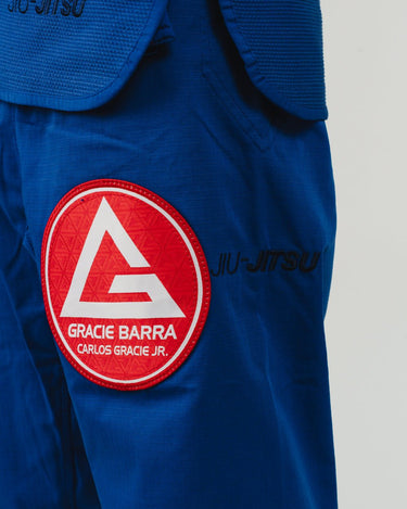 Close-up of blue Pro Lite Comp Kimono by adidas showing Gracie Barra patch and Jiu-Jitsu embroidery on the pants