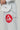 Close-up of left side of Pro Lite Comp Men’s Kimono by adidas in white showing Gracie Barra patch and Jiu-Jitsu embroidery on pants
