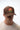 Man in a brown Gracie Barra Arte Suave cap seen from the front, highlighting the red and green grappling patch with Arte Suave script.