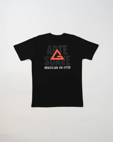 Back view of the black Arte Suave V2 kids’ T-shirt by Gracie Barra, featuring a large red Legacy G logo over black “Arte Suave” text with “Brazilian Jiu-Jitsu” in white, displayed on a light gray background.