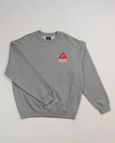 Grey Arte Suave V2 men’s crewneck sweatshirt in French terry by Gracie Barra, featuring red Legacy G chest logo with “Brazilian Jiu-Jitsu” text in white and ribbed cuffs and hem.