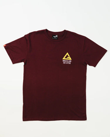 Front view of Arte Suave V2 men’s maroon T-shirt with yellow Legacy G logo and “BRAZILIAN JIU-JITSU” text in white on the left chest, displayed on a white background.