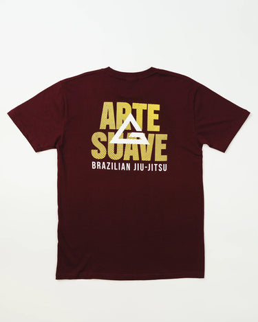 Back view of Arte Suave V2 men’s maroon T-shirt with large yellow Legacy G logo overlaid on bold “Arte Suave” text and “Brazilian Jiu-Jitsu” in white, displayed on a white background.