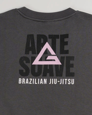 Close-up of back graphic on dark grey Arte Suave V2 women’s crewneck sweatshirt by Gracie Barra, featuring large “Arte Suave” text with integrated flow pattern, pink Legacy G logo, and “Brazilian Jiu-Jitsu” text in white.