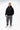 Arte Suave V3 Mens Hoodie in black, front full-length on model with gray pants. Silver Legacy G logo and white 'Arte Suave' chest script, kangaroo pocket.