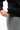 Arte Suave V3 Mens Hoodie in black, close-up of the ribbed hem and kangaroo pocket with a woven side tag at the seam, worn with gray pants.