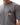 Arte Suave V3 Mens Tee in gray, front view on the model showing the chest print: black Legacy G logo above white 'Arte Suave' script.
