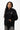 Arte Suave V3 Womens Hoodie in black, front full-length on model worn with jeans and sneakers, silver Legacy G logo and white 'Arte Suave' chest script.