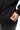 Arte Suave V3 Womens Hoodie in black, close-up of the hidden side-zip pocket being unzipped, with ribbed cuff and hem.
