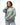 Arte Suave V3 Womens Hoodie in sage, three-quarter front on model. Relaxed oversized fit, black Legacy G logo and white 'Arte Suave' chest script.