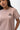 Arte Suave V3 Womens Tee in mauve, chest close-up on the model: black Legacy G logo and white 'Arte Suave' script, with a crew neck.