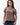 Arte Suave V3 Womens Tee in mocha, front view on the model with a crew neck. Chest print: black Legacy G logo above white 'Arte Suave' script.