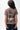 Arte Suave V3 Womens Tee in mocha, back view on the model. Full-back print: white 'Arte Suave' script, dark tonal figure, white 'Gracie Barra' wordmark.