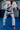 Gracie Barra professor wearing the white AXIS Kimono by adidas in a grappling stance on blue mats inside a Gracie Barra school.