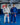 Two Gracie Barra professors standing on blue mats wearing the AXIS Kimono by adidas in white and blue colorways inside a Gracie Barra school.