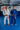 Two Gracie Barra professors standing on blue mats wearing the AXIS Kimono by adidas in white and blue colorways inside a Gracie Barra school.