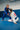 Rear view of the white Axis Womens Kimono by adidas in seated guard during training, with the red back patch and gray sleeve stripes.
