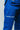 Close-up of the white Competition print on the thigh of blue Atleta ripstop gi pants, worn under a blue Gracie Barra kimono jacket