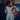 Gray Gracie Barra Balance Sports Bra shown from the front with the hem being adjusted, highlighting the smooth compression fit and cropped length.