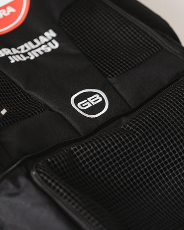 Close-up of front mesh panels on Black Barra da Tijuca Backpack showing GB circle logo embroidery and “Brazilian Jiu-Jitsu” text above the Barra shield emblem.