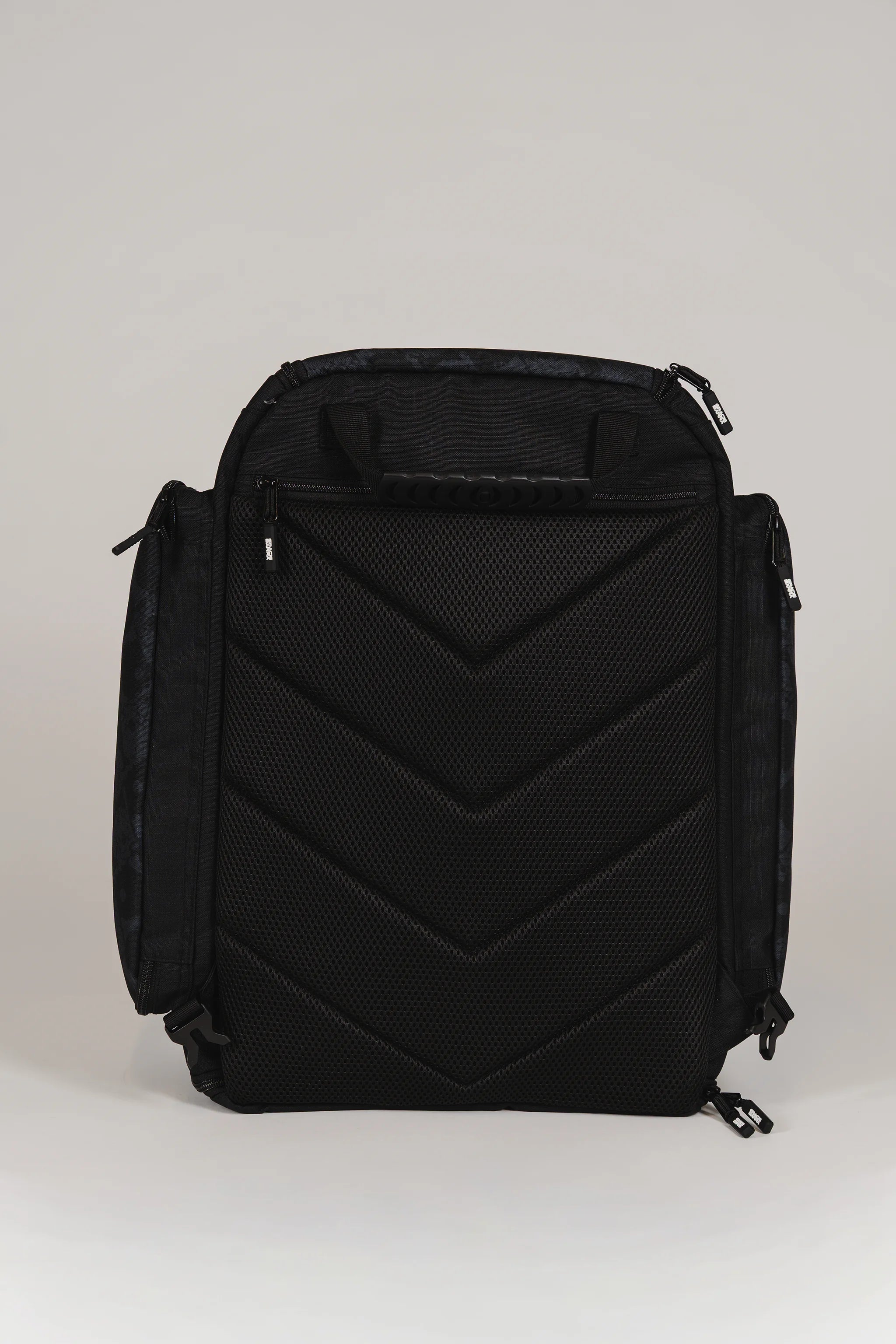 Back view of Black Barra da Tijuca Backpack with shoulder straps tucked in, showing padded mesh back panel and duffel carry configuration option.
