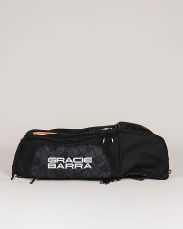 Side view of Black Barra da Tijuca Backpack with lower compartment expanded, showing “Gracie Barra” logo and calçadão pattern panel in duffel configuration.