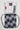 Folded Barra da Tijuca White Kimono jacket with visible Red Shield and Gracie Barra patches, displayed above the patterned drawstring bag inspired by Barra da Tijuca sidewalk mosaics.