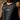 Close-up of the gray stacked Gracie Barra chest logo and textured knit fabric on the black Terra Mar tank.