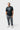 Student wearing the black Barra da Tijuca Terra Mar tee, full front view with the square boardwalk-tile chest graphic and white Legacy G triangle.