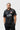 Black Gracie Barra Barra Origins soccer jersey, straight-on front view with the Gracie Barra chest wordmark, red Barra Shield and relaxed vintage fit.