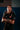 Model with arms crossed in the black Barra Origins jersey, showing the red-tipped collar, red sleeve cuff stripes, and GB sleeve print.