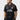 Student wearing the black Barra Origins jersey, front view with red-tipped collar, white piping, Barra Shield and BRAZILIAN JIU-JITSU chest print.