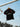 Black Gracie Barra Barra Origins kids' jersey, front view with Brazilian Jiu-Jitsu chest graphic, Red Shield, and red-tipped collar.