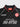 Collar of the black Barra Origins kids jersey with red trim, a repeating Jiu-Jitsu and Legacy G collar band print, and red Gracie Barra neck label.