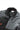 Close-up of the BarraTec Fleece Youth Jacket in black focusing on the insulated stand collar, grid fleece upper construction, full-length zipper, and internal Gracie Barra label detail, photographed on a white background.