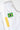 Close-up of the white Brasileiro Youth Kimono pants. Brazilian flag patch beside yellow adidas three-stripes.