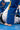 Close-up of the Brasileiro Youth Kimono by adidas pants in blue with yellow three-stripe detail and yellow JIU-JITSU embroidery down the leg.