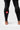 Red circular Barra Shield logo on the lower calf of the black Gracie Barra Close Contact Compression Pants, with flatlock seam detail at the ankle hem.