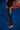 Full-length side view of the black Close Contact compression pants on the mat, showing the gray Gracie Barra side panel and red Barra Shield at the calf.