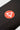 Close-up of the red Barra Shield logo on the lower leg of the black Gracie Barra Close Contact kids compression pants.