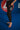Young Gracie Barra student on a blue mat wearing the black Close Contact kids compression pants with gray striped Gracie Barra side panel.