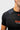 Gray shoulder panel and raglan sleeve seam on the black Gracie Barra Close Contact Rashguard, shown close up from the front.